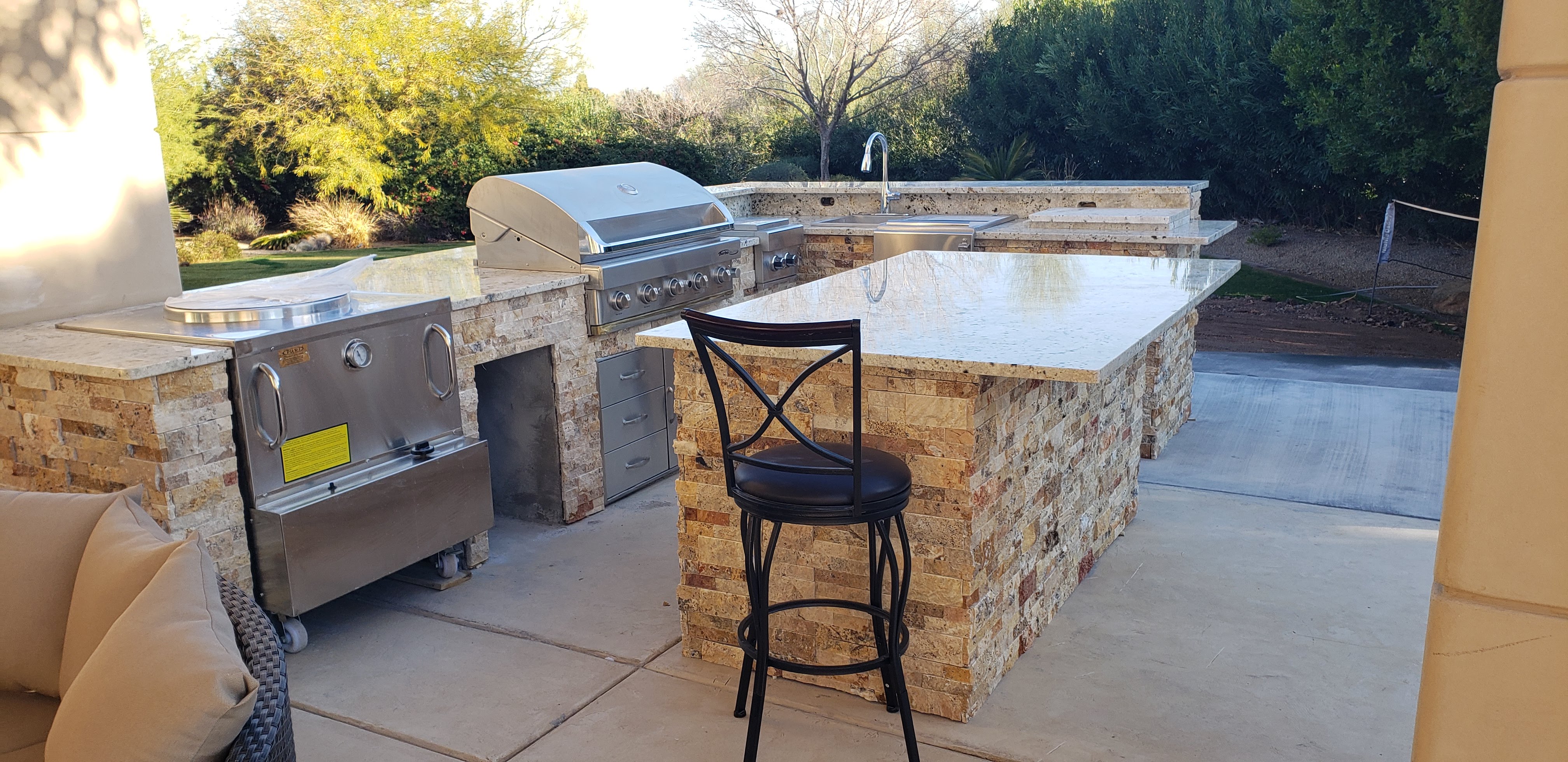 Luxury Travertine Outdoor Kitchen — landscaping project in Surprise, AZ by Sophora Landscaping